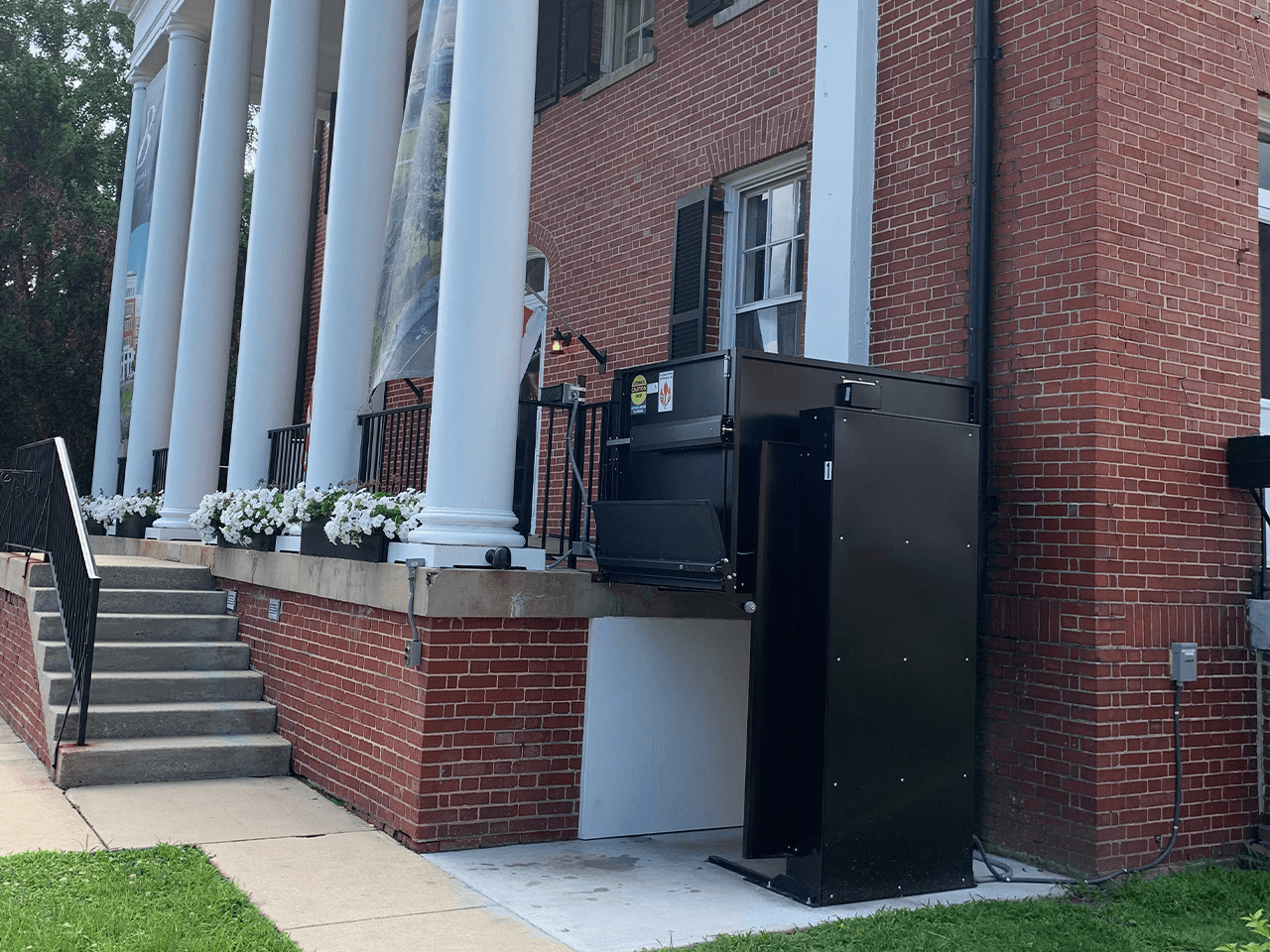 unenclosed lift UL outdoor at upper landing with flip up ramp