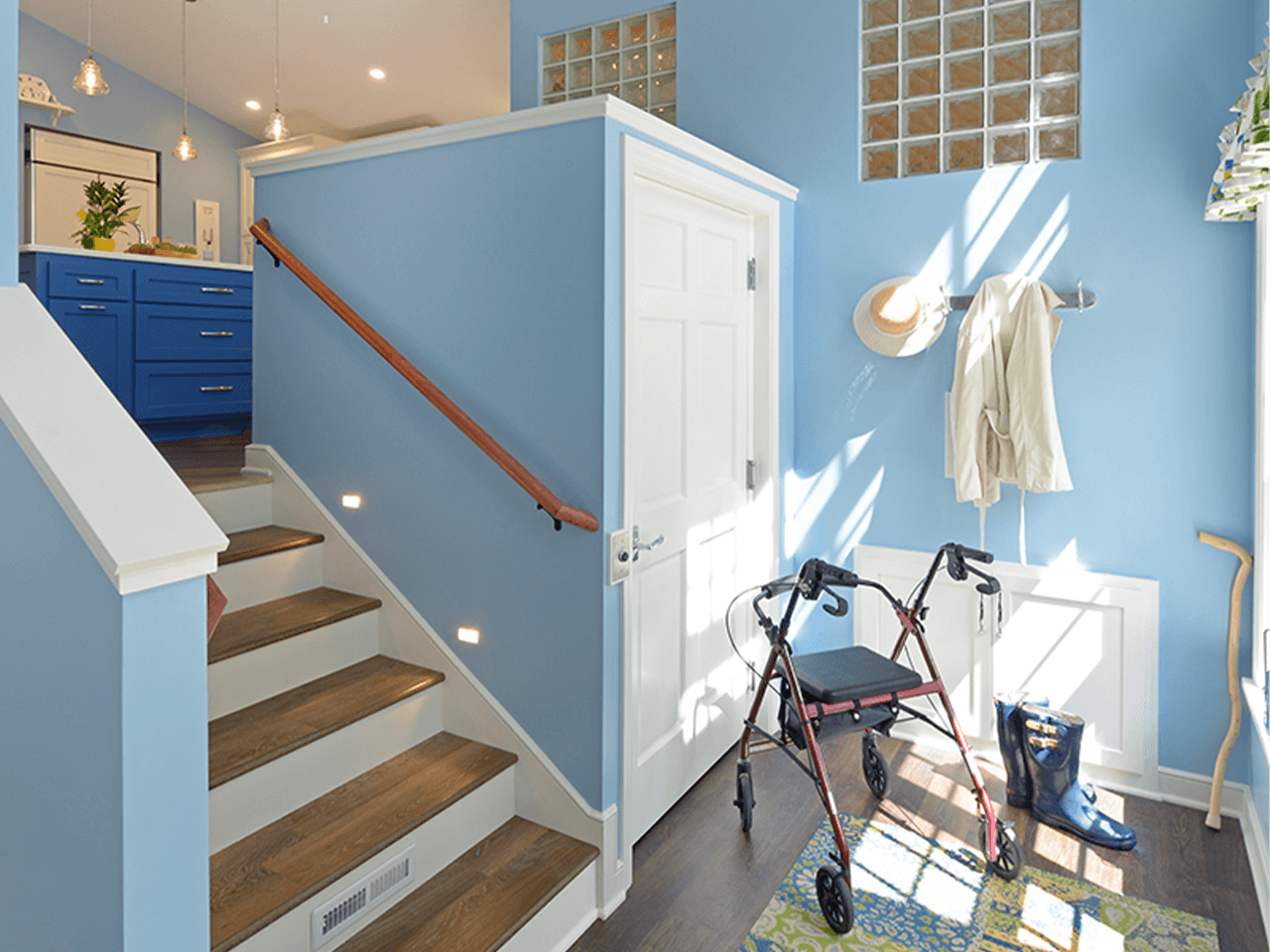 Symmetry shaftway lift custom vpl next to stairs in home with walker and blue walls