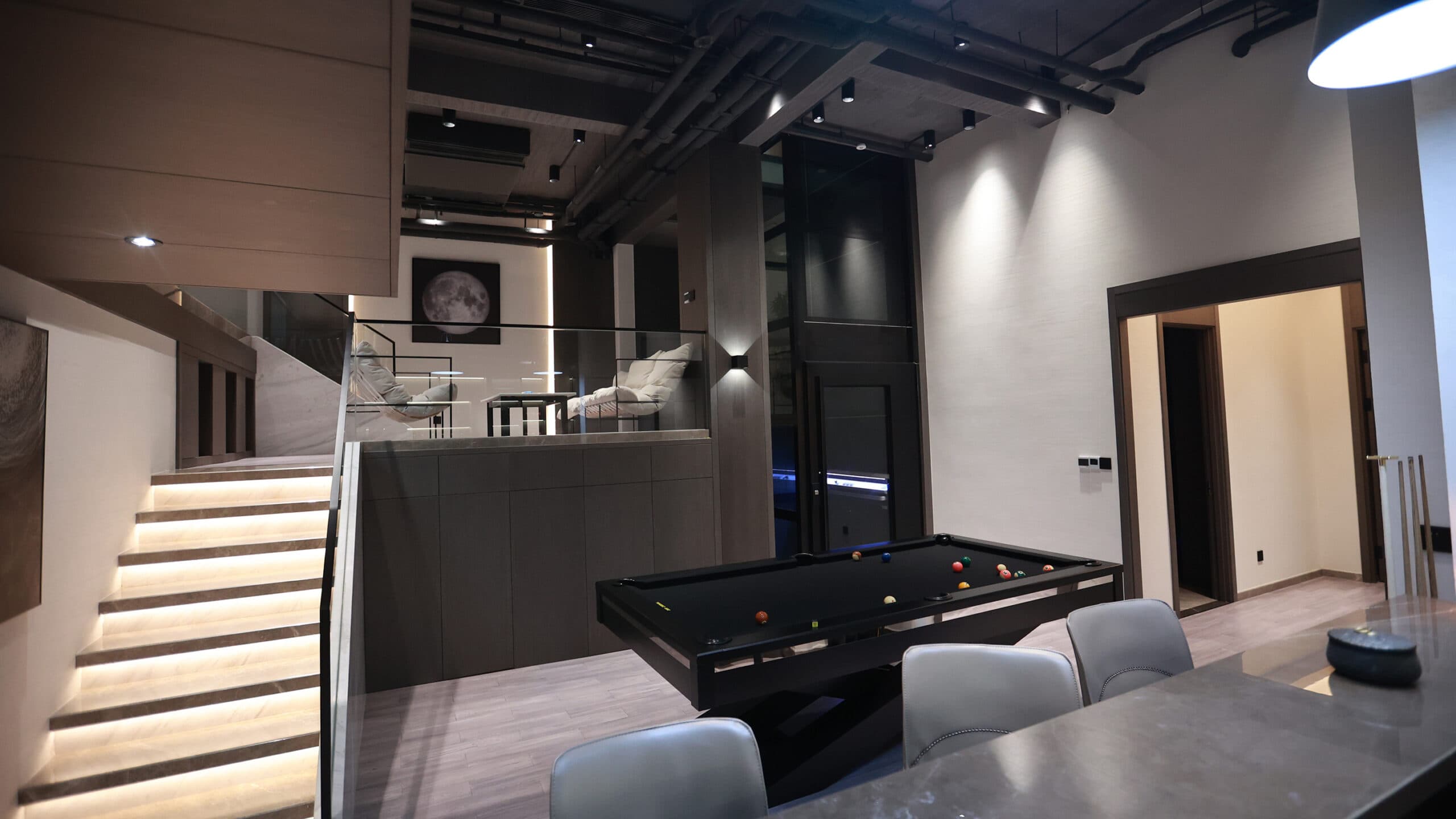Black Cibes primo platform lift with a glazed shaft in a bar