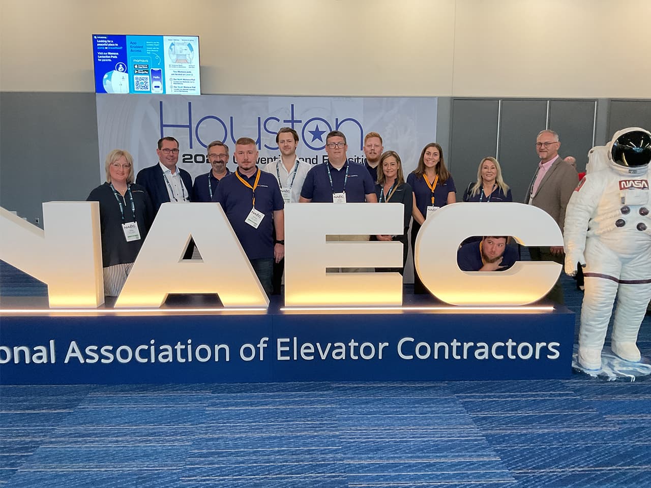 Cibes Symmetry team at NAEC 2025 in Houston Texas showcasing new accessibility solutions including Glass Double Landing Doors, 3 Panel Doors in Gothic Black, and Dream Cab Packages