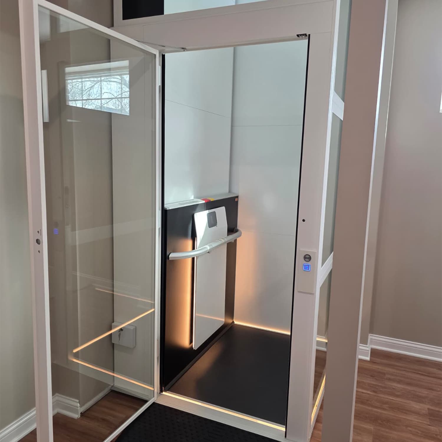 First Cibes Air residential lift installation in Fort Wayne, Indiana with white shaft and glass doors.