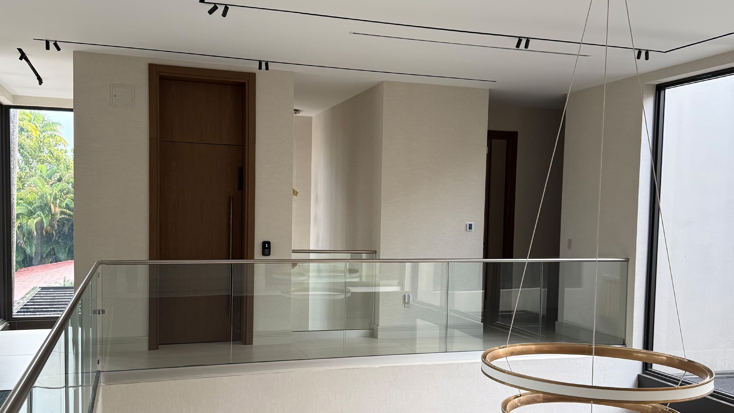 Symmetry Asterix home elevator installed beside staircase in Miami residence