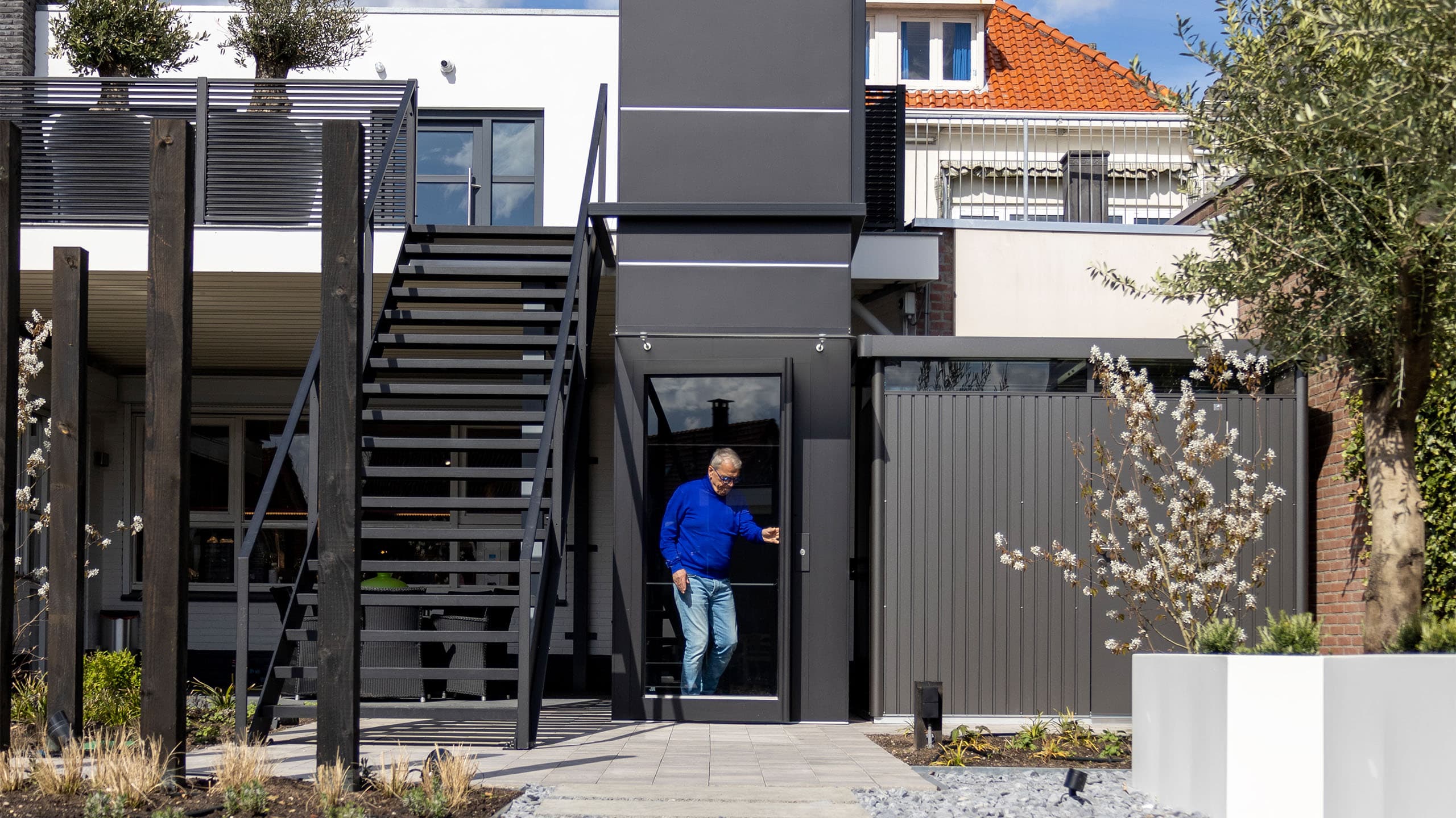 outdoor home elevator providing access to raised residential entry